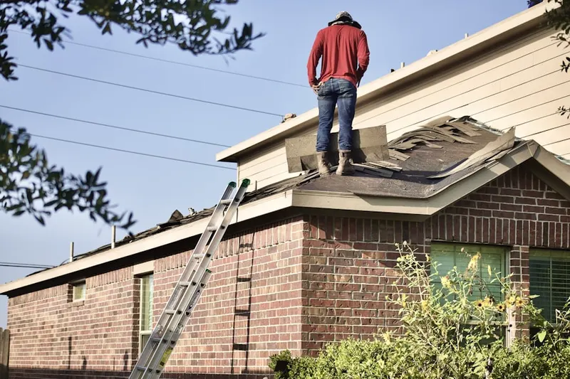 Professional roofer working on a residential roof in Village Walk
